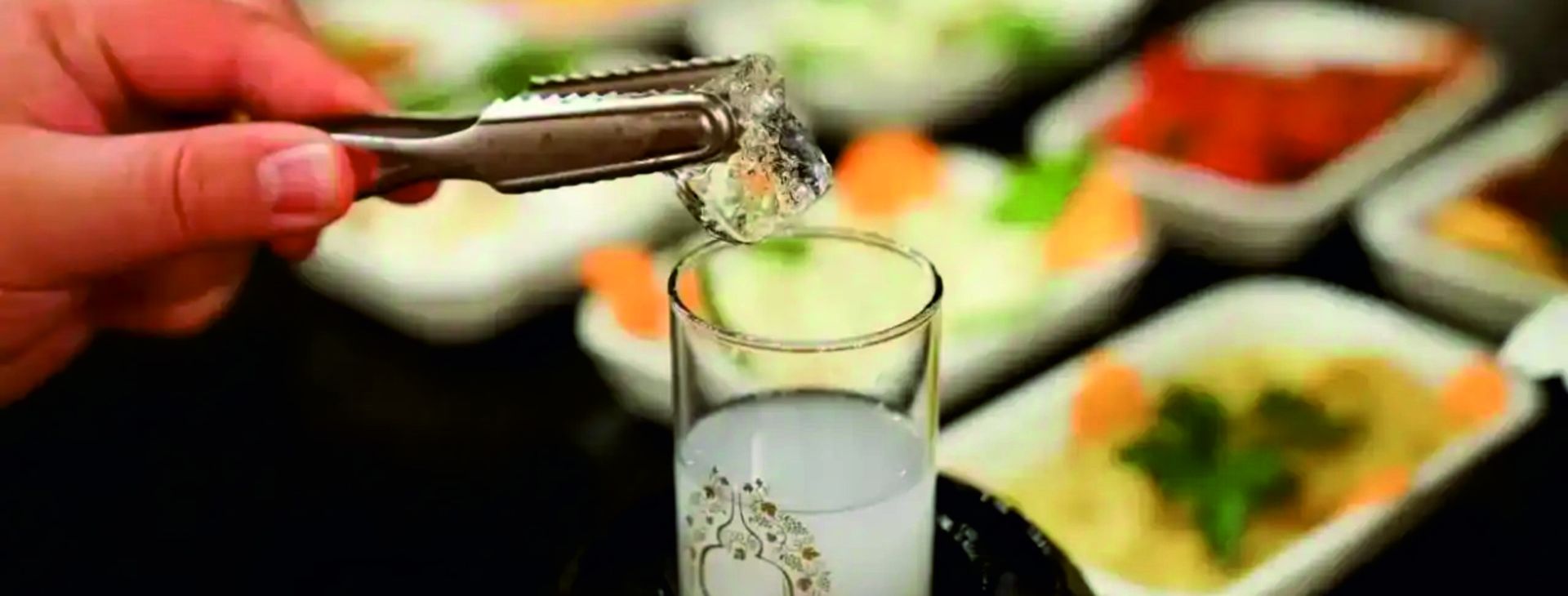 Rakı wird eingeschenkt, dahinter Meze